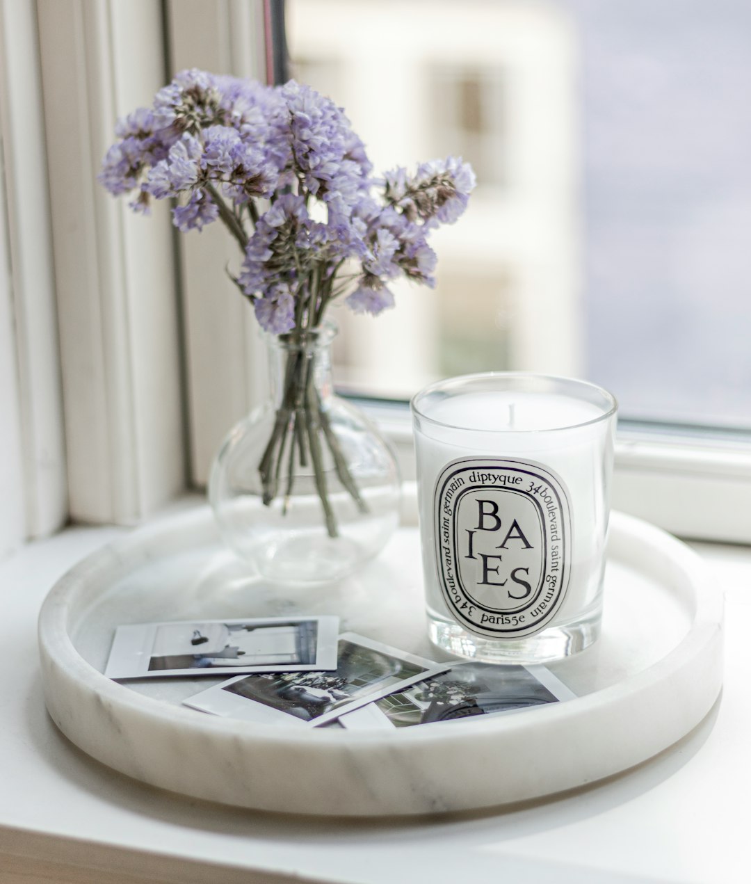 Flowers with scented candle and polaroids 